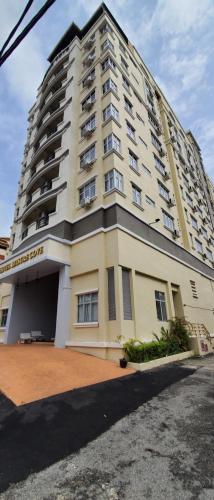 a large white building with a lot of windows at Leisure Cove Hotel and Apartments in George Town