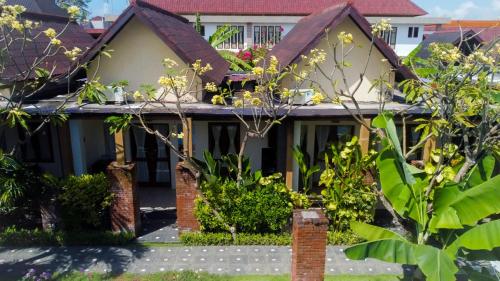a house with a garden in front of it at The Janan Villa in Sanur