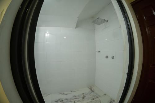a mirror in a bathroom with a marble floor at 17 Large room for two people in Torreón