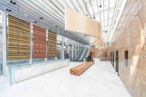 a lobby of a building with a bench and windows at Oasia Resort Sentosa by Far East Hospitality in Singapore