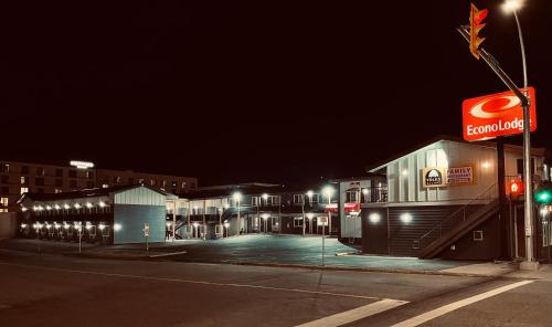 an empty parking lot in a city at night at Econo Lodge in Prince George