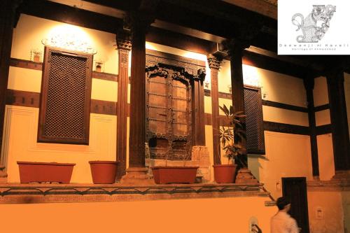 a person walking in front of a building at Deewanji Ni Haveli in Ahmedabad