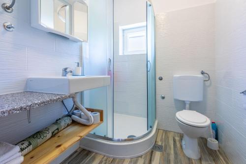 a bathroom with a shower and a sink and a toilet at Apartments Rozaria in Dramalj