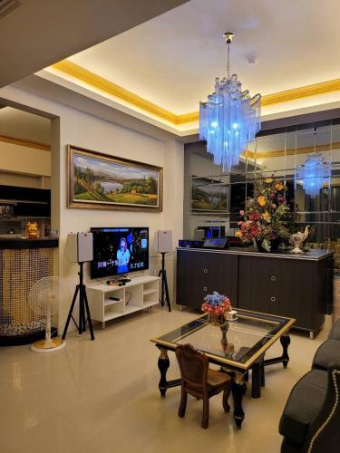 a living room with a chandelier and a table at 北歐小宅-市區電梯民宿附停車位 in Hualien City