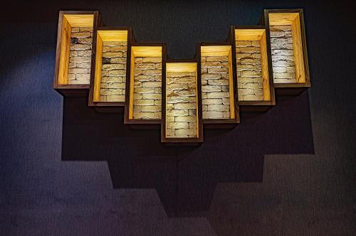 a group of wooden books on a wall at Regenta Inn Sambalpur, Farm Road in Sambalpur