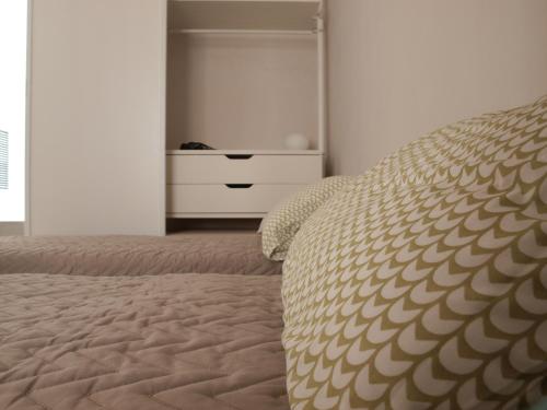 a bedroom with a bed and a dresser with a drawer at Casa vacanze "Officina del fabbro" - Menfi in Menfi