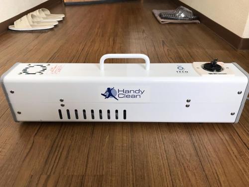 a white battery delivery box sitting on the floor at 民宿さざんか in Okinawa City