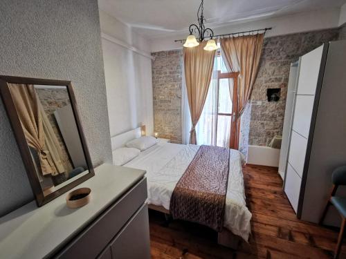 1 dormitorio con cama, espejo y ventana en Apartments Relax Zone, en Umag