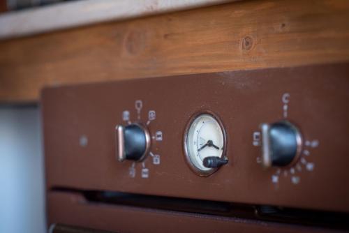 a close up of a clock on top of an oven at Zempléni Szálláshely in Fony