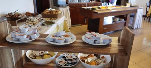 a table with several plates of food on it at Hotel S.Maria in Brenzone sul Garda