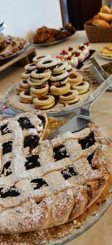 a table topped with pies and pastries on display at Hotel S.Maria in Brenzone sul Garda