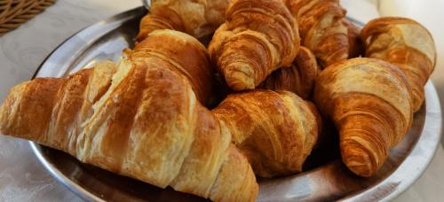 a bunch of croissants on a plate on a table at Hotel S.Maria in Brenzone sul Garda