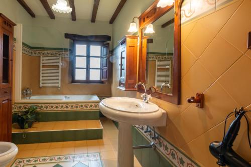a bathroom with a sink and a tub at Luxury Villa Esmeralda in Suances