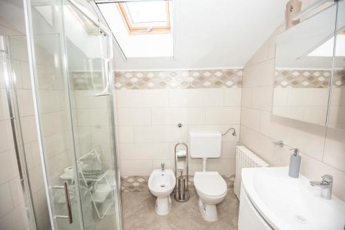 a bathroom with a toilet and a sink and a shower at Villa Mira Zagreb in Kraljevec Kupinečki