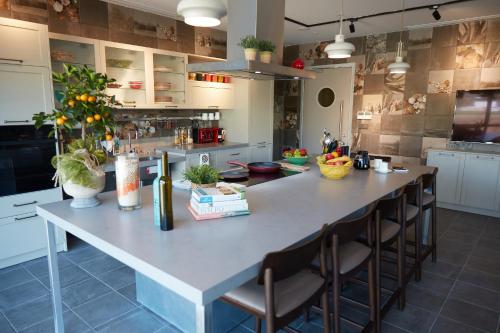 a large kitchen with a large island with chairs at Antwell Suites in Istanbul