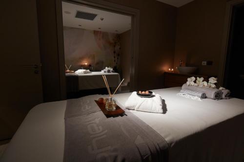 a bedroom with a large bed with candles on it at Antwell Suites in Istanbul