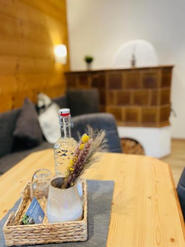 a basket with a bottle on a table at Haus Schatzbergblick in Oberau