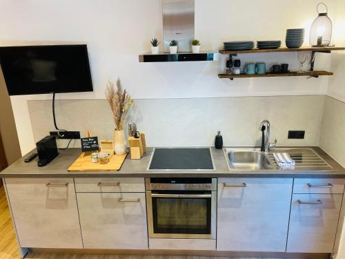 a kitchen with a sink and a counter top at Haus Schatzbergblick in Oberau