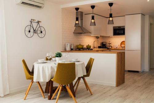 a kitchen with a table with a bike on the wall at Falésia 25 in Albufeira