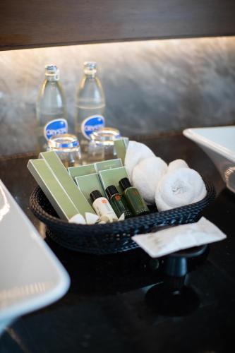 a basket with toiletries and bottles on a table at Thantara Resort Chiang Mai in Chiang Mai