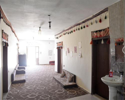 a hallway with a sink and a toilet in a room at Happy Bedouin House Petra in Al Ḩayy