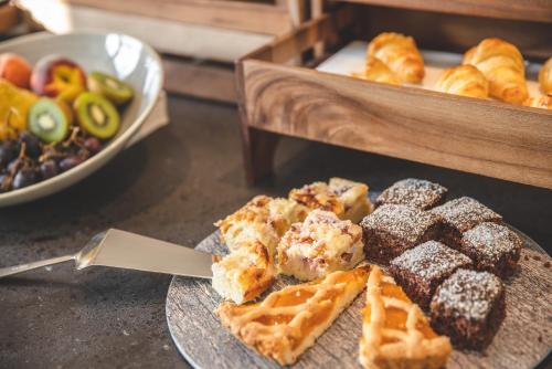 a plate of waffles and other pastries on a table at Forest Resort in Vír