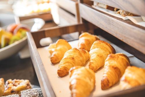 a bunch of croissants on a shelf in a bakery at Forest Resort in Vír