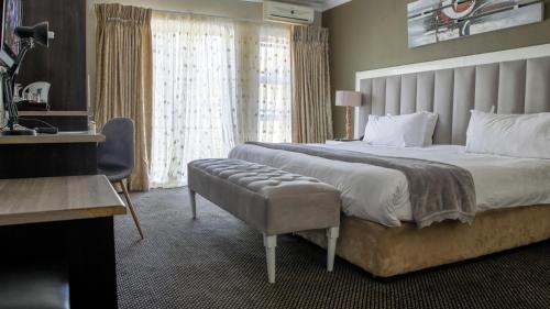 A bed or beds in a room at Ruby Stone Boutique Hotel