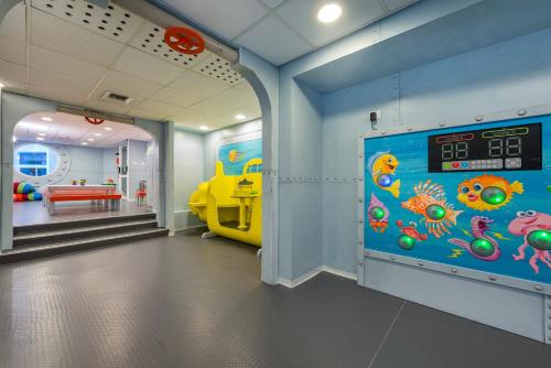 a room with a wall with a clown fish mural at Sport Club by Isrotel Collection in Eilat
