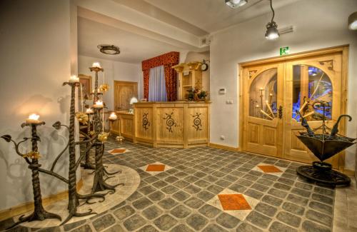 a large room with a large wooden door and an umbrella at Willa Kominiarski Wierch in Zakopane