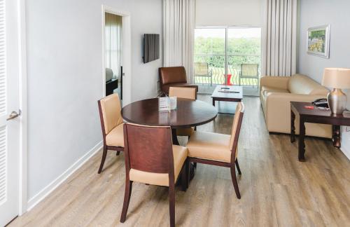 a living room with a table and chairs and a couch at Meliá Orlando Celebration in Orlando