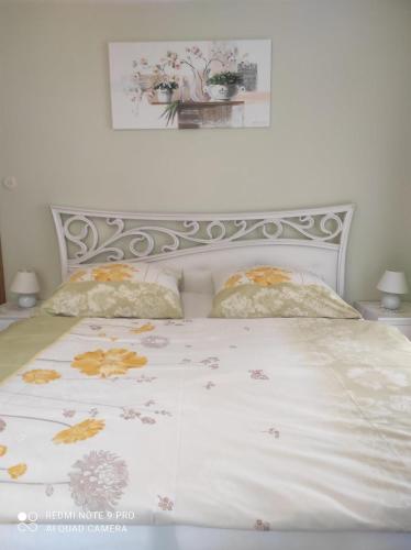 a bed with a white comforter and two pillows at Haus Mühlenheim in Schwendau