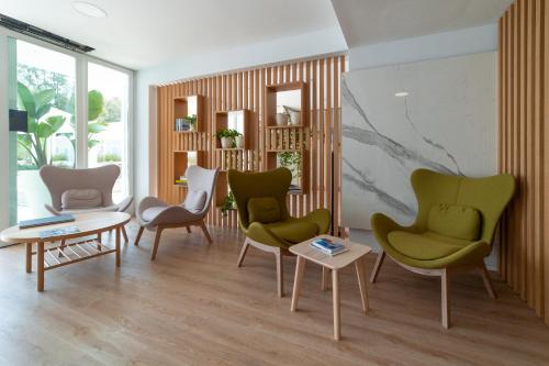 a living room with chairs and a table at Plana Resort & SPA in Castel Volturno