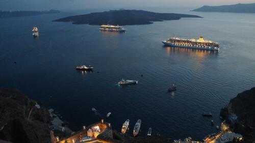 a group of boats in a large body of water at Villa Bordeaux in Fira