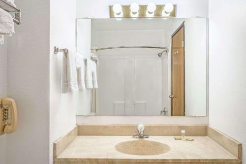 a bathroom with two sinks and a mirror at Super 8 by Wyndham Price in Price