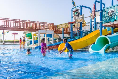 a family playing in the water at a water park at The Art Hotel & Resort in Manama