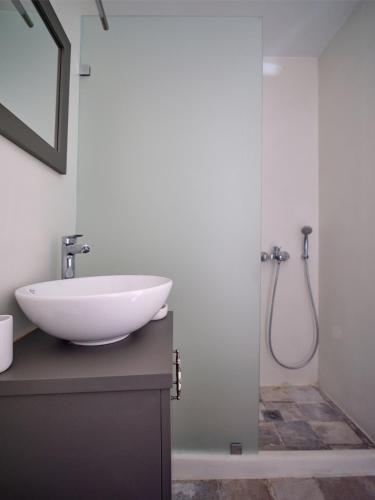 a bathroom with a sink and a shower at Retreat Paros - The Loft Apartment in Parikia