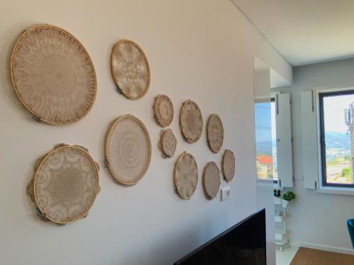 a group of plates hanging on a wall at Casa da Zéfinha, em Cinfães, no Douro in Cinfães