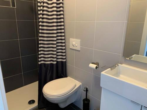 a bathroom with a toilet and a sink at BEACH SEA VIEW APPARTMENT in Podgora
