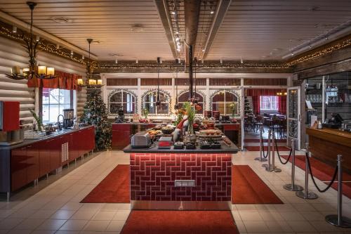 a kitchen with a island in the middle of a room at Santa Claus Holiday Village in Rovaniemi