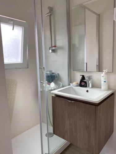 a bathroom with a sink and a shower at Casa Foz Marina in Figueira da Foz