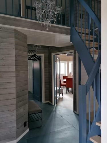 a hallway with a staircase with a blue stair case at Andøy Vest Rorbuer Reine in Reine