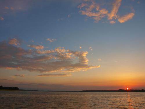 a sunset over a body of water at Stara Kuźnia Mazurska in Węgorzewo