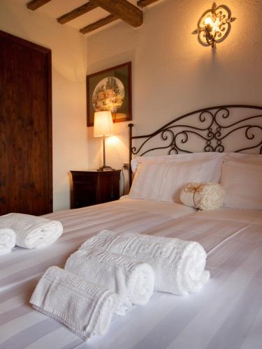 a bedroom with a bed with white towels on it at Riserva Privata San Settimio in Arcevia