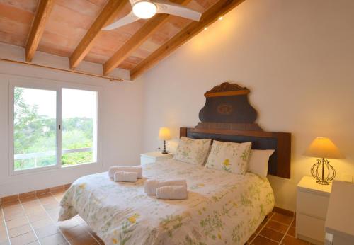 a bedroom with a bed and a large window at Alconasser 3 - Amazing Seaviews between Deia & Soller in Sóller