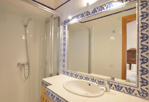 a bathroom with a sink and a large mirror at Alconasser 3 - Amazing Seaviews between Deia & Soller in Sóller
