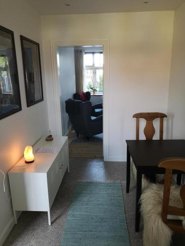 a living room with a table and a couch at Safine B&B in Fåborg