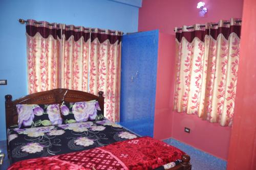 a bedroom with a bed with pink and blue walls at Yelagiri EGV Residency in Yelagiri