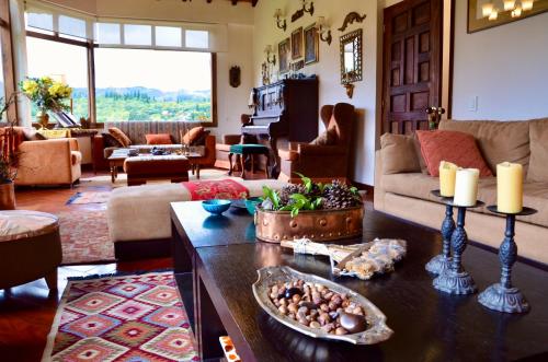 a living room with a couch and a table at Sumangá Hotel Boutique in Sutatausa