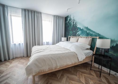 a bedroom with a bed with a painting on the wall at Kościerzynkowo in Kościerzyna